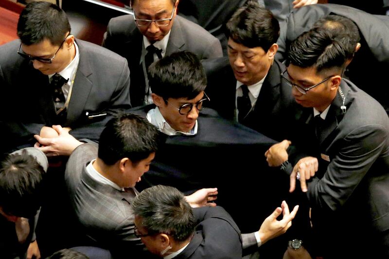 Security guards block pro-independence legislator-elect Baggio Leung from retaking his oath inside the Legislative Council in Hong Kong, China, Nov. 2, 2016. Credit: Reuters