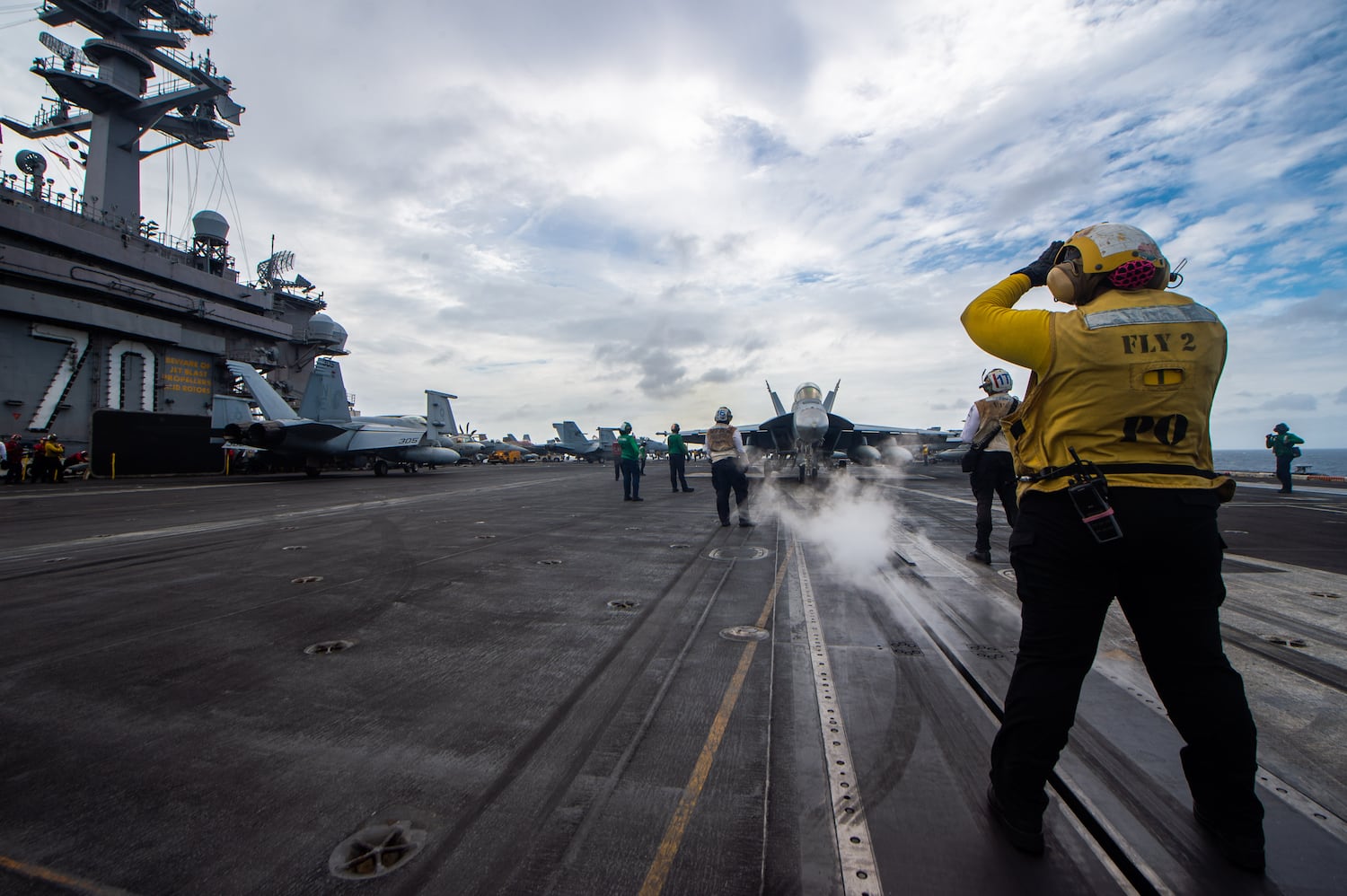 Sailors signal aircraft during routine flight operations on the flight deck of the USS Carl Vinson on Jan. 7, 2025.