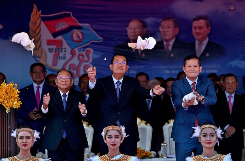 Leader of Cambodian People's Party Hun Sen and his son Prime Minister Hun Manet release pigeons during a ceremony to mark the 45th anniversary of the fall of the Khmer Rouge regime in Phnom Penh on Jan. 7, 2024. (Tang Chhin Sothy/AFP)