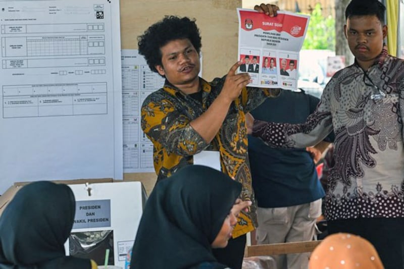 An election official holds up a ballot paper during counting at a polling station after voting ended in Indonesia's presidential and legislative elections in Banda Aceh, Aceh, Indonesia, Feb. 14, 2024. (Chaideer Mahyuddin/AFP)