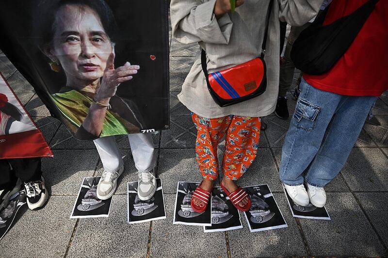 Protesters step on images of Myanmar junta leader Senior Gen. Min Aung Hlaing during a demonstration outside the UN office in Bangkok on Feb. 1, 2024, to mark the third anniversary of the coup in Myanmar. (Lillian Suwanrumpha/AFP)