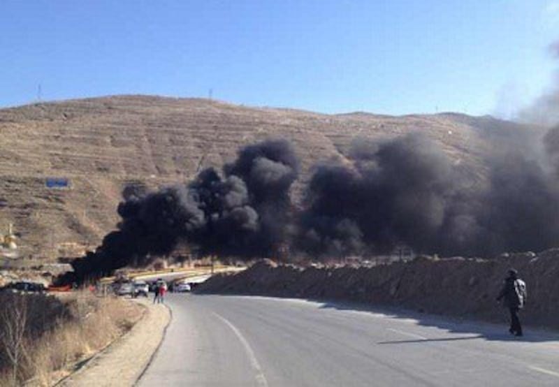 Smoke billows from burning satellite equipment in Malho prefecture. Photo courtesy of an RFA listener.