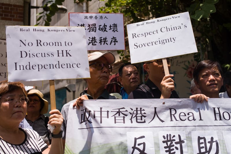 Members of a pro-government group gather outside the Foreign Correspondents' Club to protest against the club holding a scheduled talk by pro-independence advocate Andy Chan, in Hong Kong, Aug. 8, 2018.