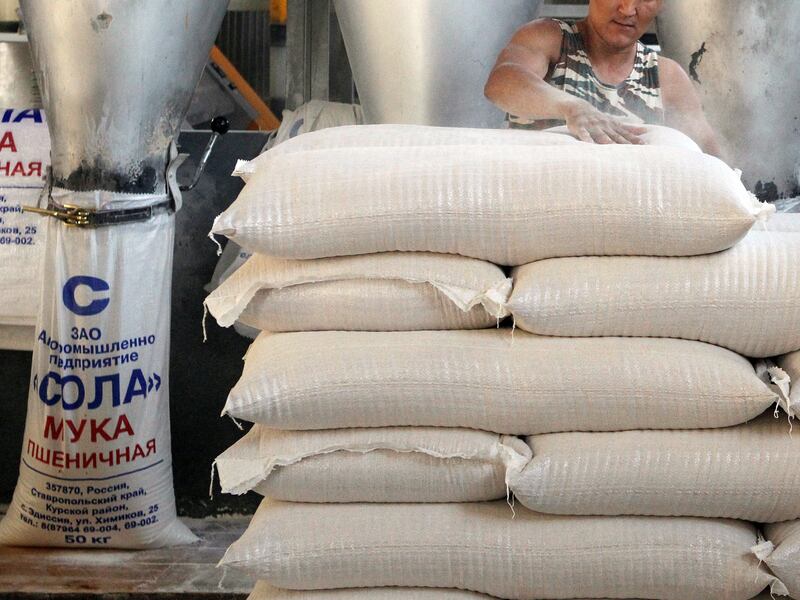 A worker packs sacks of wheat flour at a flour mill in the village of Edissiya, in Stavropol region, Russia.  (Reuters/Eduard Korniyenko)