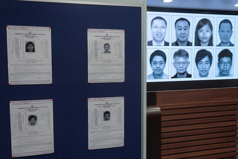 Photos of eight activists who are sought by Hong Kong police are displayed during a press conference in Hong Kong, July 3, 2023. Credit: Joyce Zhou/Reuters