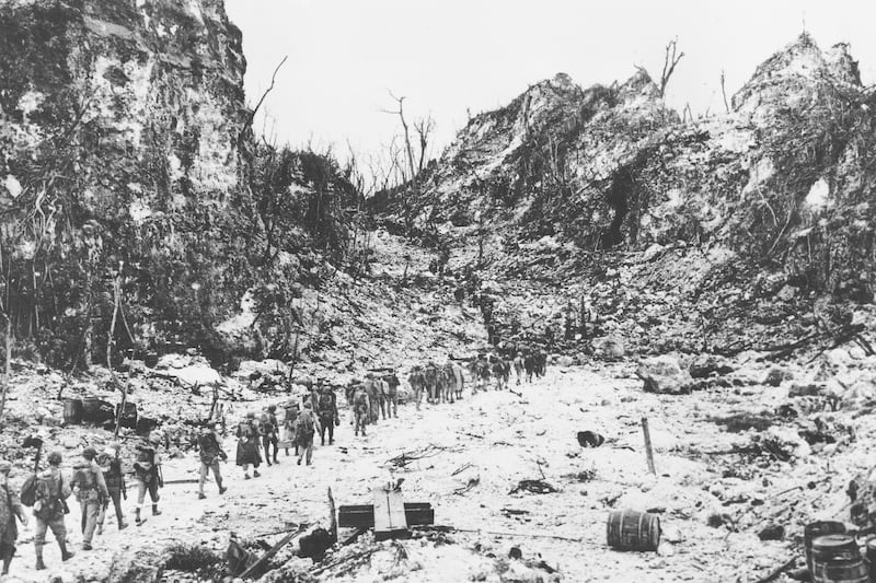 U.S. Marines move up to the front lines over terrain denuded by the bombardment of Peleliu to mop-up Japanese forces, Oct. 12, 1944.