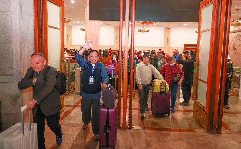 Travelers walk toward the first Beijing-Laos cross-border tourist train at the Beijing Railway Station on March 18, 2024. (Jia Tianyong/China News Service/VCG via Getty Images)