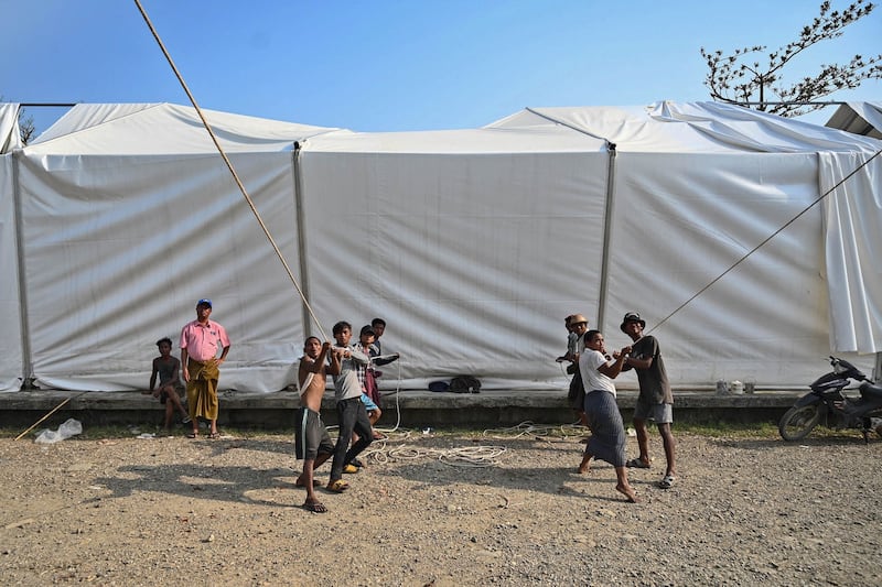 Workers rebuild a damaged UN World Food Program warehouse in Sittwe in the aftermath of Cyclone Mocha's landfall. Credit: Sai Aung Main/AFP