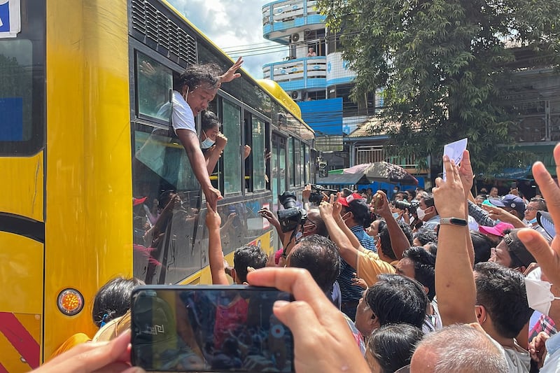 Supporters greet a bus carrying detainees out of Insein Prison in Yangon on the second day of a prisoner amnesty, Oct. 19, 2021. RFA