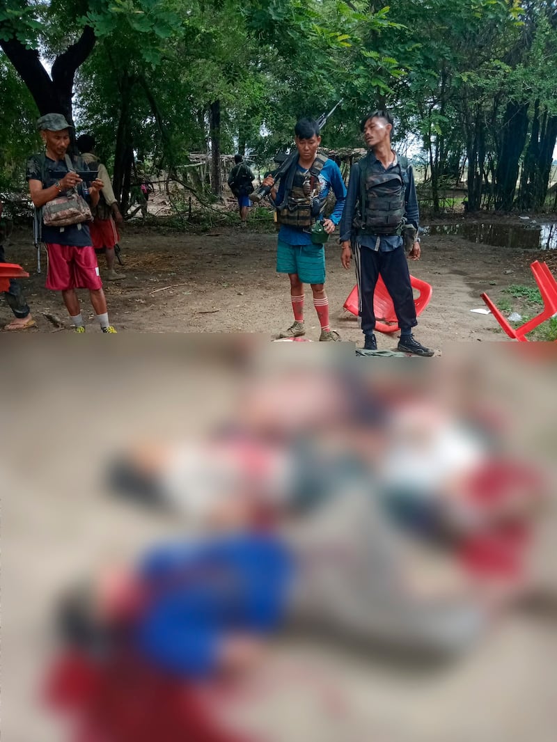 This photo (blurred to cover the graphic scene) shows the phone owner and a man who also appeared in the video standing next to five slain men lying in pools of blood. Two of the slain men also can be seen in the photo from the previous day showing about 30 men with their hands tied behind their backs on the grounds of Mon Taing Pin monastery.