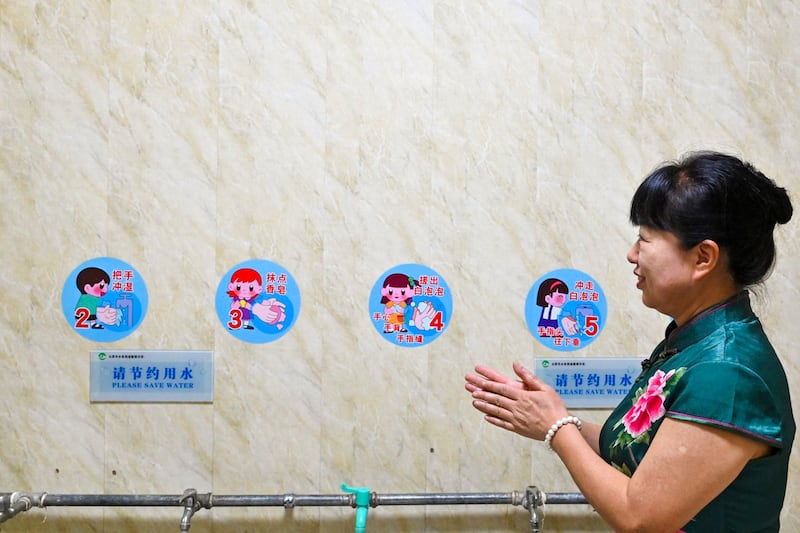 Principal Li Xiuling washes her hands in a wash room once used by children at a kindergarten-turned-elderly centre in Taiyuan, in China's northern Shanxi province, July 1, 2024. Senior citizens sway to old-time tunes in the classroom of a former kindergarten in northern China, as educators turn their sights away from children in the face of a rapidly aging population and a baby bust. (Adek Berry/AFP)