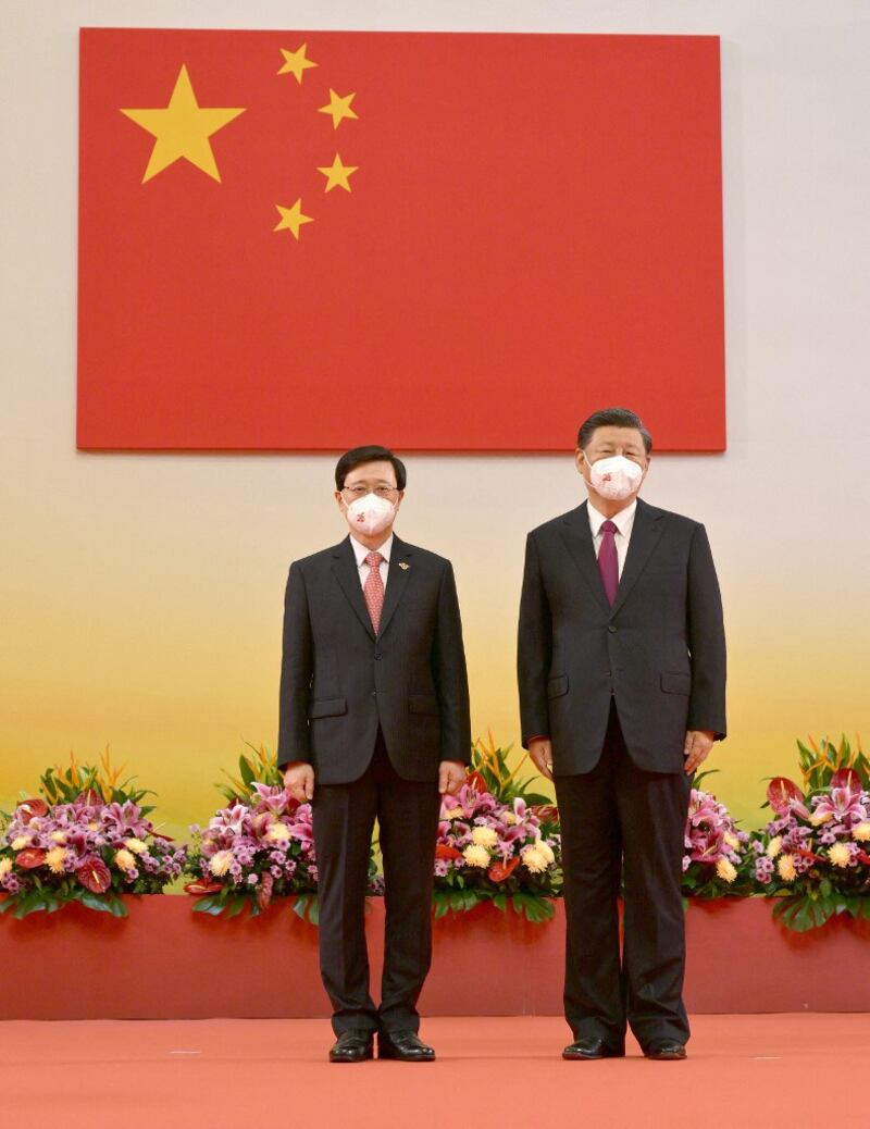 China's President Xi Jinping (R) standing with Hong Kong's new Chief Executive John Lee (L) after Lee was sworn in as the city's new leader, during a ceremony to inaugurate the city's new government in Hong Kong on July 1, 2022. Credit: Hong Kong's Information Services Department.