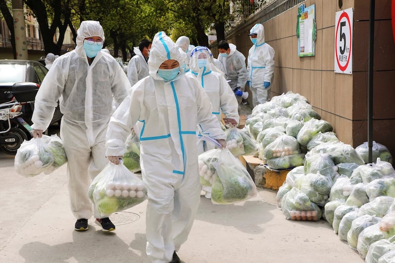 Volunteers carry daily necessities for residents of the Fengxian district of Shanghai, March 28, 2022. Credit: Xinhua via AP