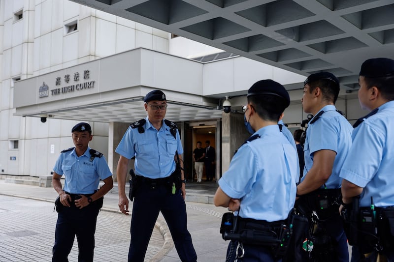 Police stand guard outside the High Court ahead of the hearing for an injunction to ban the 2019 protest anthem “Glory to Hong Kong,” in Hong Kong, July 21, 2023. Credit: Tyrone Siu/Reuters