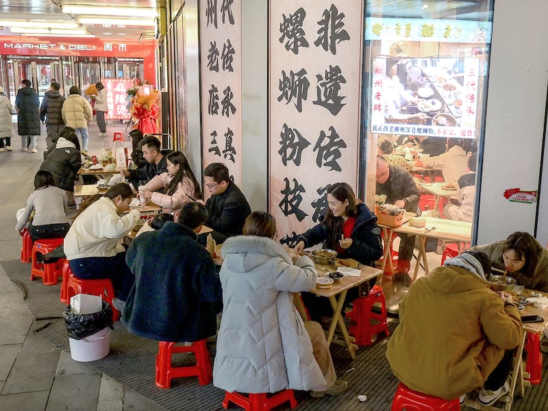 People dine outside a restaurant in Beijing on Jan. 18, 2025.