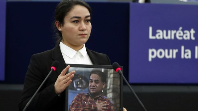 Jewher Ilham holds a photo of her father, Ilham Tohti, during the Sakharov Prize ceremony at the European Parliament, in Strasbourg, France, Dec. 18, 2019. Credit: AP Photo