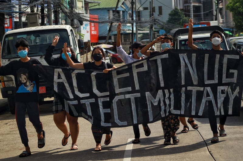 Youths march in support of the National Unity Government's declaration of war on the junta with a banner reading 'Accept NUG, Reject the Military' in Yangon, Sept. 7, 2021. RFA