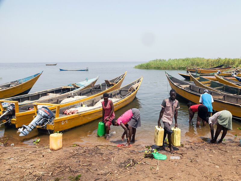 People fetch water on the shores of Lake Albert in Buliisa, Uganda, Jan. 21, 2023.