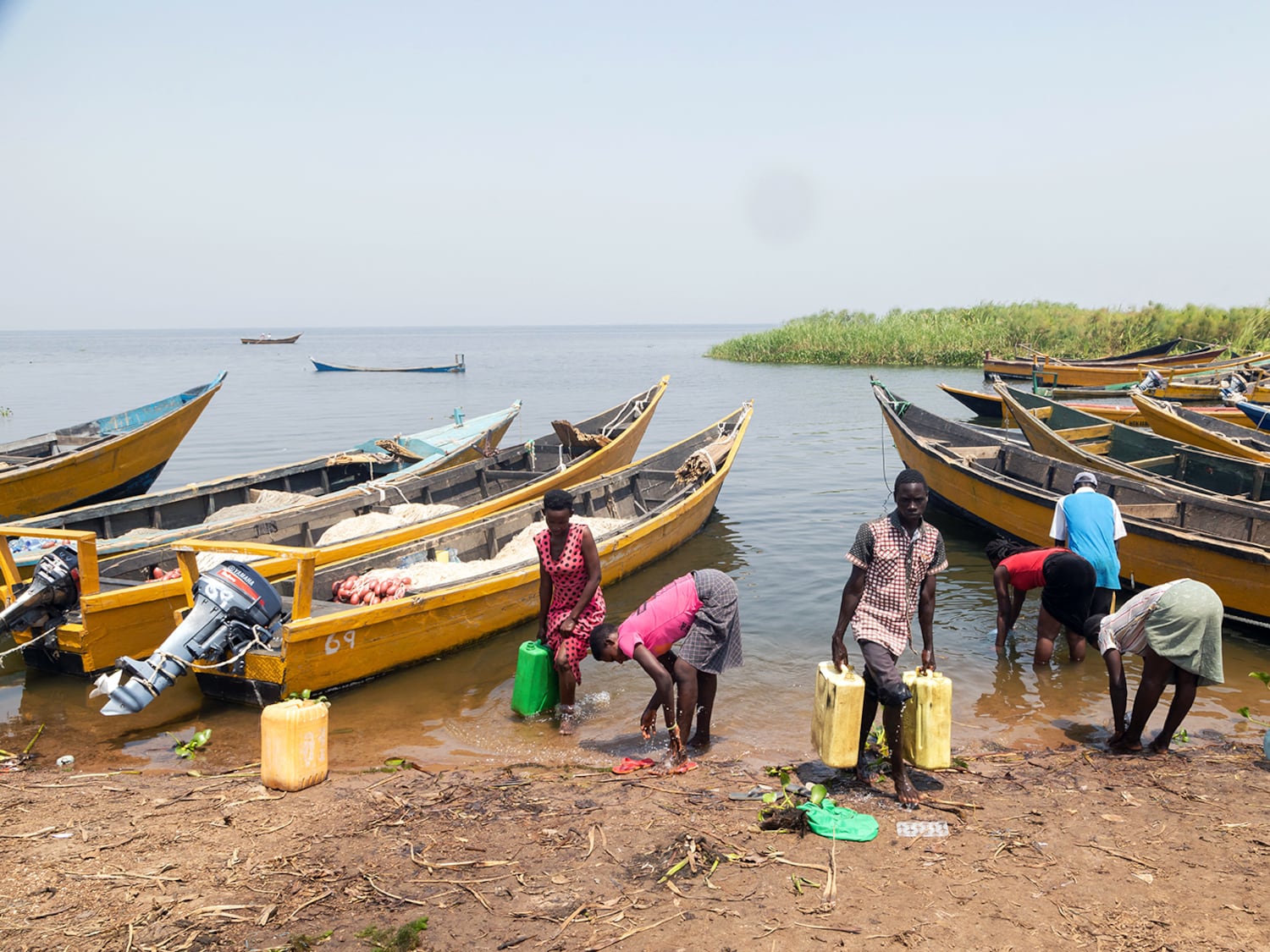 People fetch water on the shores of Lake Albert in Buliisa, Uganda, Jan. 21, 2023.