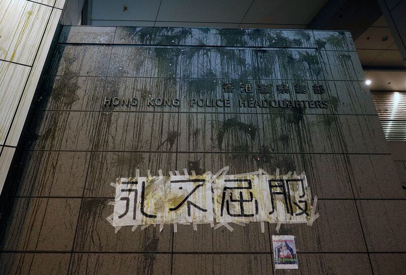 2019年6月21日，抗议者抛出的鸡蛋溅在香港警察总部的一面墙上，上面写着“永不放弃”的横幅。（美联社）