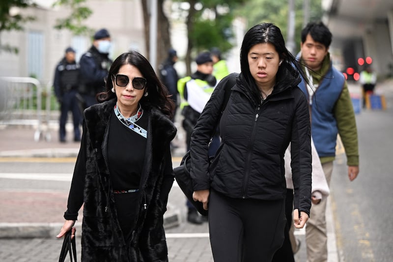 Teresa Lai [left], wife of Jimmy Lai, and their daughter Claire Lai and son Lai Shun Yan arrive at the West Kowloon Court in Hong Kong on Friday, Dec. 22, 2023. (Peter Parks/AFP)