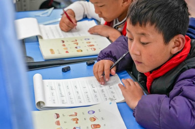 Tibetan students learn Tibetan writing in a first-grade class at the Shangri-La Key Boarding School during a media-organized tour, in Dabpa county, Kardze Prefecture, southwestern China's Sichuan province, Sept. 5, 2023. (Andy Wong/AP)