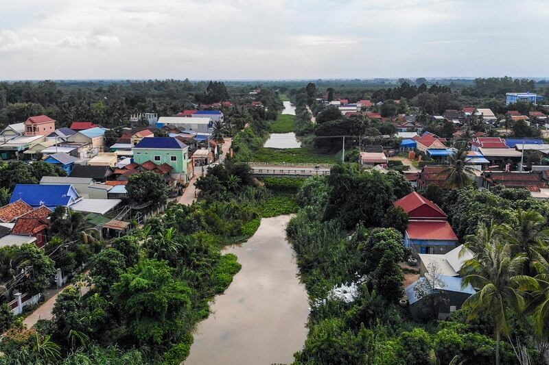 Residential homes along the Prek Ta Hing channel, where the proposed second phase of the Funan Techo canal is set to be built, in Kandal province, July 9, 2024. (Tang Chhin Sothy/AFP)