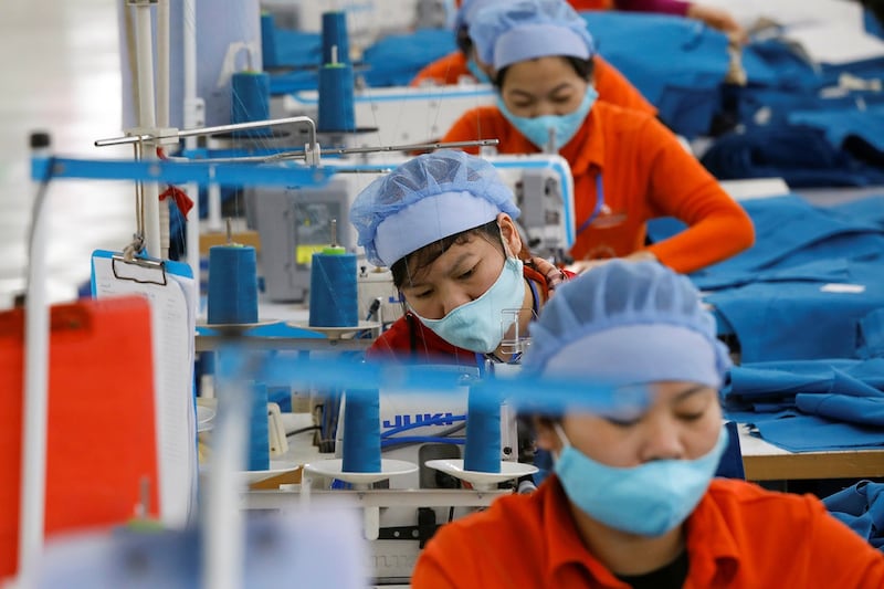 Women work at the Hung Viet garment export factory in Hung Yen province, Vietnam, Dec. 30, 2020. (Kham/Reuters)