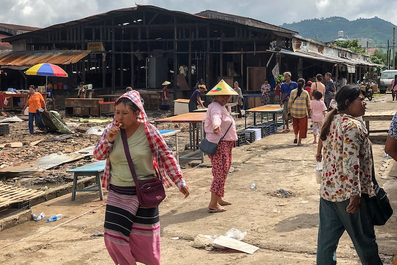 People walk though a market area on Sept. 10, 2024, as it’s being rebuilt in Lashio in Myanmar's northern Shan state, after the Myanmar National Democratic Alliance Army (MNDAA) seized the town from Myanmar's military in August.