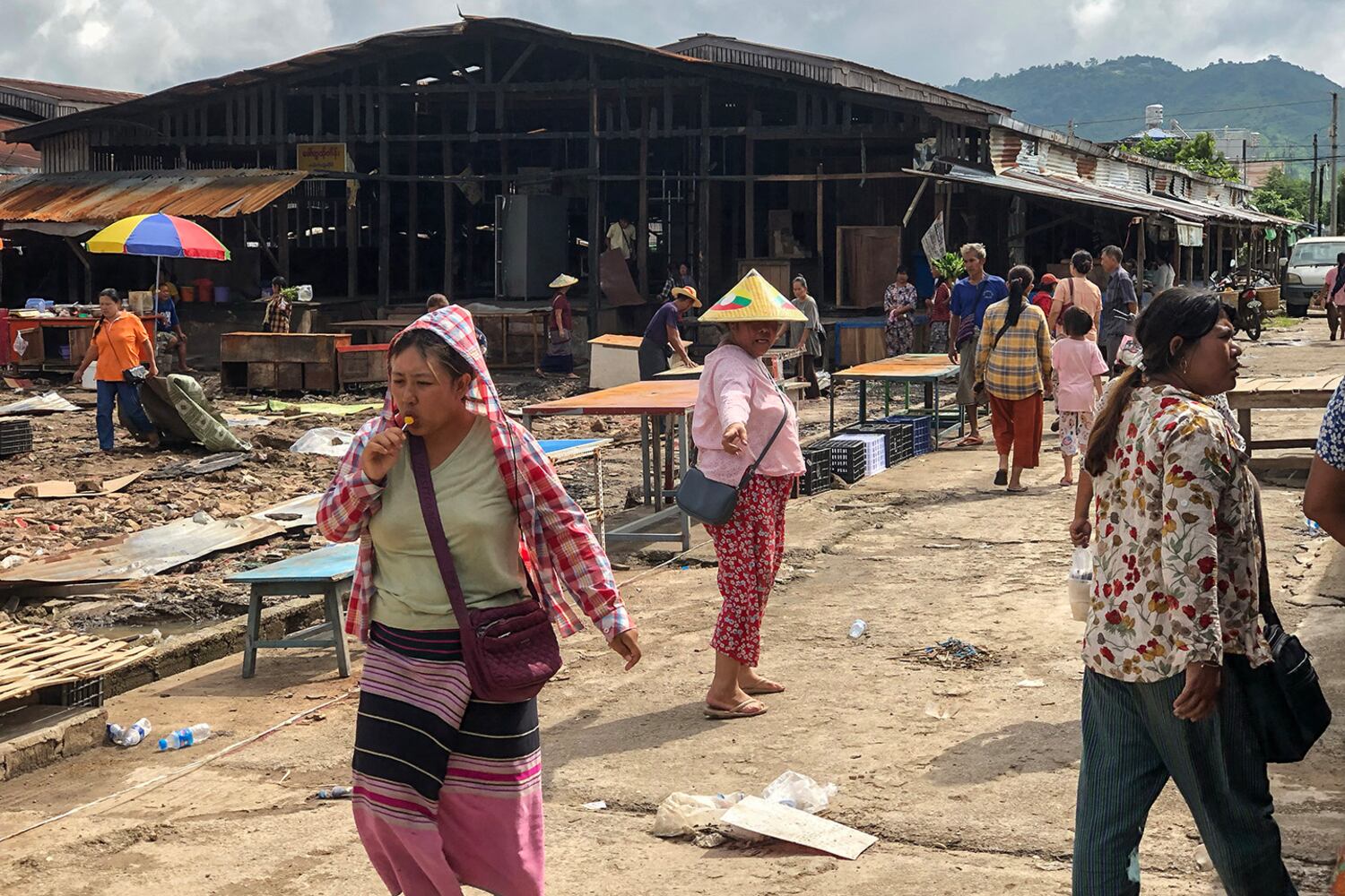 People walk though a market area on Sept. 10, 2024, as it’s being rebuilt in Lashio in Myanmar's northern Shan state, after the Myanmar National Democratic Alliance Army (MNDAA) seized the town from Myanmar's military in August.