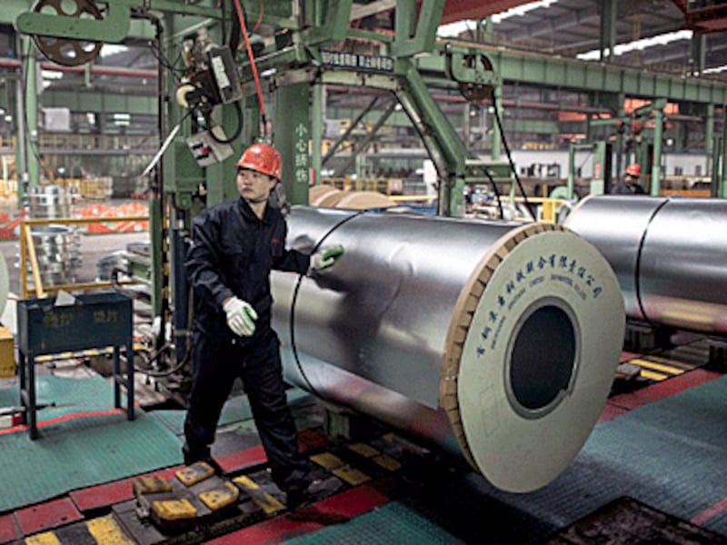 A Chinese worker packs steel rolls in a steel factory in Tangshan, northern China's Hebei province, May 12, 2016.