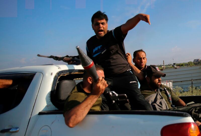 Palestinian militants carrying what appears to be a North Korean F-7 rocket propelled grenade launcher [with red band] drive back to the Gaza Strip, Oct. 7, 2023. Credit: Ali Mahmud/AP