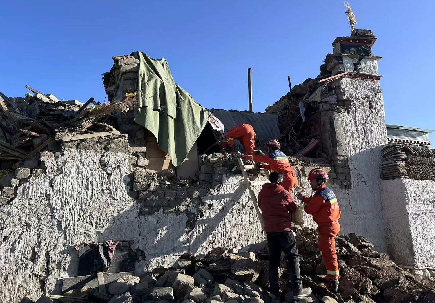 Rescue workers search for survivors in the aftermath of an earthquake in Changsuo Township of Tingri, southwestern China’s Tibet Autonomous Region on Tuesday, Jan. 7, 2025.