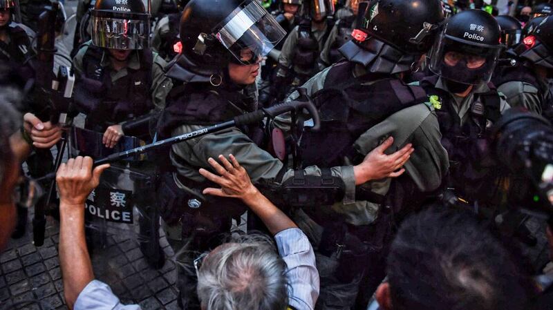 An elderly man implores police not to charge at Tung Chung MTR train station in Hong Kong, Sept. 1, 2019. 