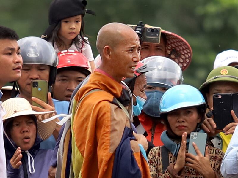 Buddhist monk Thich Minh Tue, center, standing with local residents in Vietnam's Ha Tinh province, May 17, 2024.