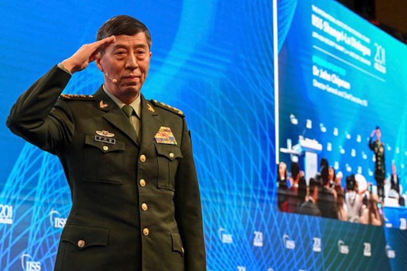 China's Minister of National Defence Li Shangfu salutes the audience before delivering a speech during the 20th Shangri-La Dialogue summit in Singapore, June 4, 2023. (Roslan Rahman/AFP)