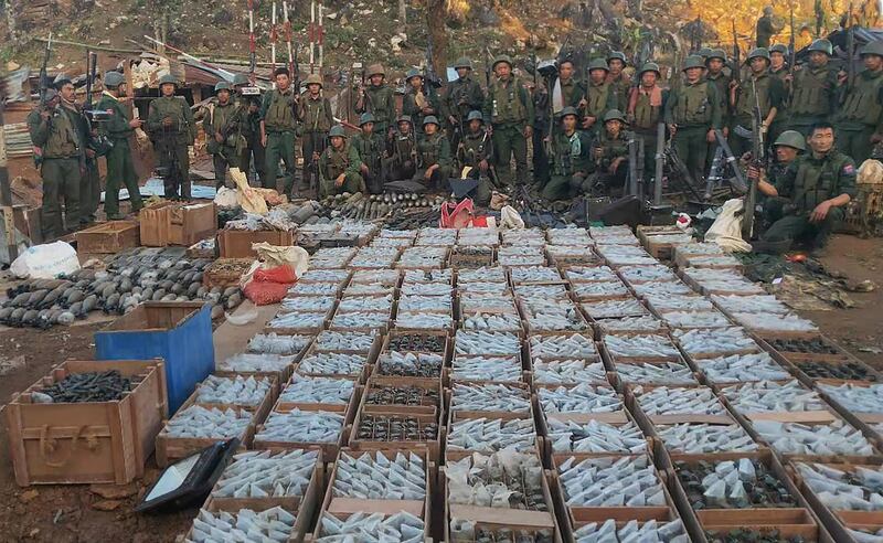 Members of the ethnic rebel group Myanmar National Democratic Alliance Army pose with weapons and ammunition they seized from Tar Kan Htan military outpost in northern Shan state near the border with China on Nov. 5, 2023. Operation-1027 launched on October 27 have swept across northern Shan State, taking control of over 126 of the military's forward operating bases. Credit: Kokang311@ facebook