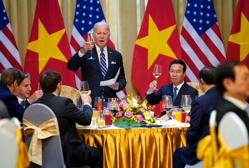 U.S. President Joe Biden raises a toast as he participates in a State Luncheon with Vietnam President Vo Van Thuong in Hanoi, Vietnam in 2023. A stream of high-level foreign visitors, including President Biden have come to court the leadership in Hanoi. (Evan Vucci/AP)