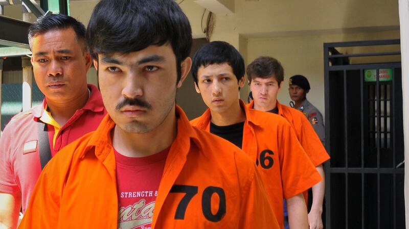 Uyghurs (L-R) Ahmet Mahmud, Altinci Bayram, and Abdul Basit Tuzer, walk to the court room in Jakarta ahead of their verdicts on terrorism charges, July 13, 2015.