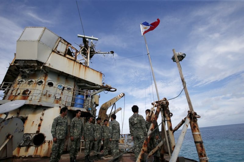 Members of Philippine Marines are pictured on the BRP Sierra Madre, a dilapidated Philippine Navy ship that was run aground in 1999 to become a military outpost at the disputed Second Thomas Shoal in the South China Sea, March 29, 2014. Credit: Reuters