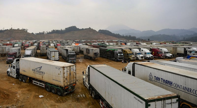 Lao and Chinese trucks wait to cross the Laos-China border at the Boten-Mohan check point in Boten village, Luangnamtha province, Laos , Dec. 5, 2021. Credit: AFP