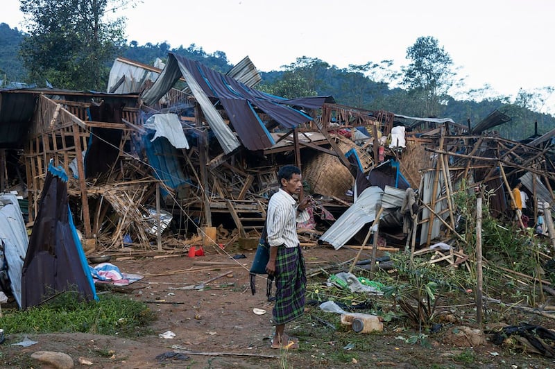 A man outside homes destroyed after air and artillery strikes in Mung Lai Hkyet displacement camp, in Laiza, Oct. 10, 2023. (AP Photo)