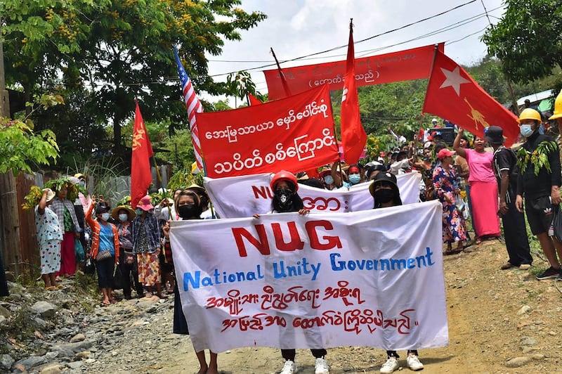 Protesters marching with banners supporting National Unity Government during a demonstration against the military coup in Hpakant in Myanmar's Kachin state, May 8, 2021. Credit: Kachin Waves via AFP