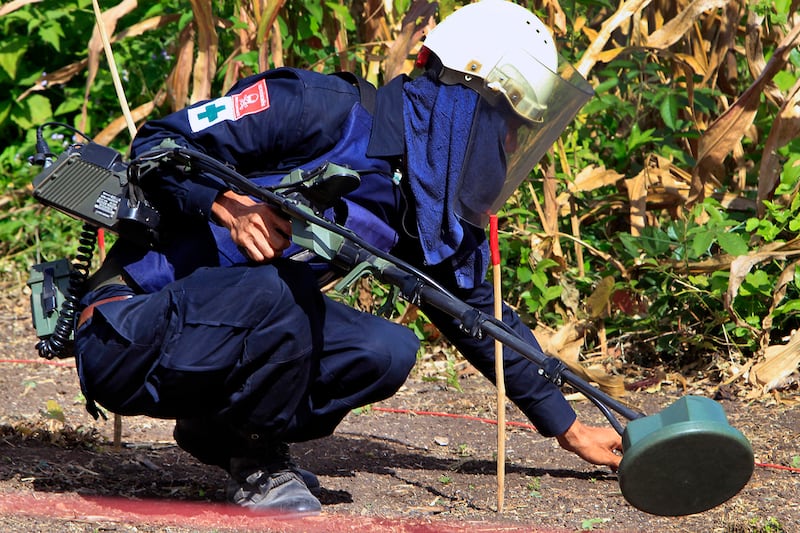 A Cambodian de-mining expert works at a site of land mines near the Cambodia-Thailand border, in Pailin province, once a Khmer Rouge stronghold in Cambodia, on Nov. 27, 2011.