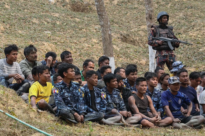 Border Guard Bangladesh personnel watch over detained Myanmar Border Guard Police who sought refuge in Teknaf on Feb. 7, 2024. (AFP)