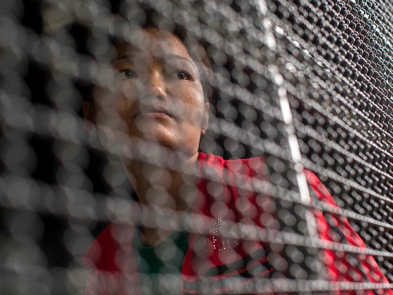 A Cambodian worker waits to cross the Thai-Cambodia border at Aranyaprathet in Sa Kaew June 15, 2014.