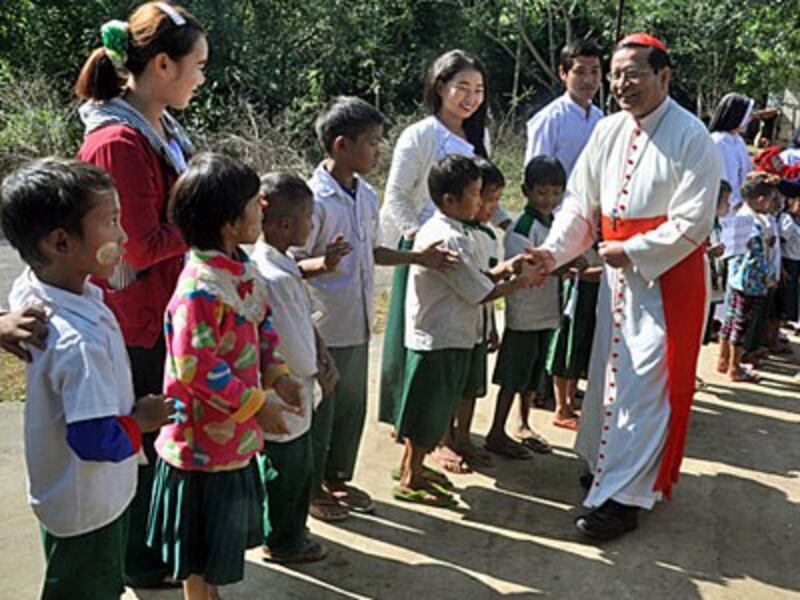 Myanmar Cardinal Charles Maung Bo greets Catholic parishoners outside a church in Tanphaye village, northern Myanmar's Kachin state, Dec. 14, 2017.