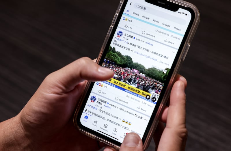 A user looking at news content on the social media site Facebook in Taipei, Dec. 22, 2023.