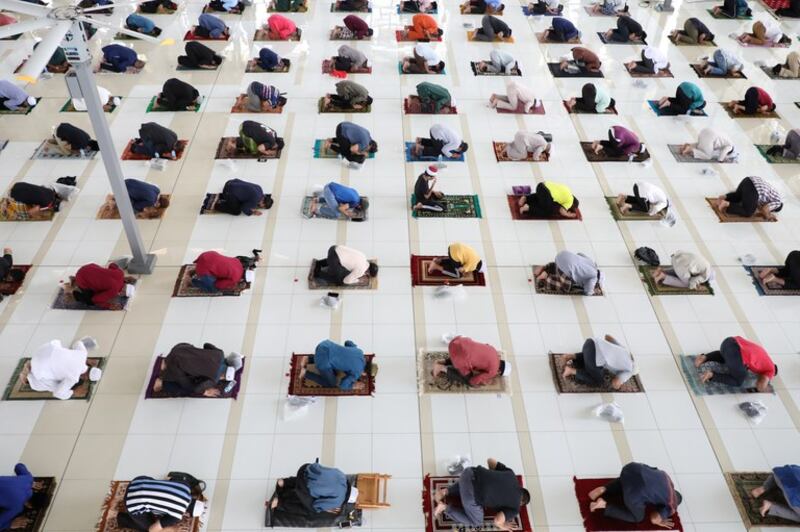 Worshipers follow social-distancing measures while praying inside a mosque during a COVID-19 lockdown in Putrajaya, Malaysia, July 16, 2021. (Lim Huey Teng/Reuters)