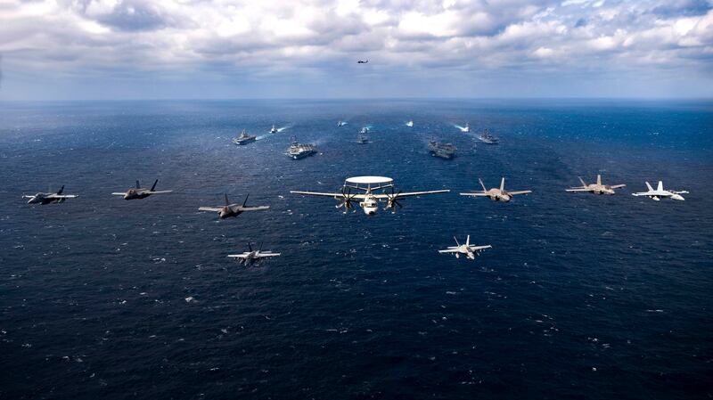 Photo of aircraft, caption: U.S. Navy aircraft taking part in a joint exercise in the Philippine Sea, Jan. 22, 2022, involving the Carl Vinson and Abraham Lincoln Carrier Strike Groups. Credit: U.S. Navy